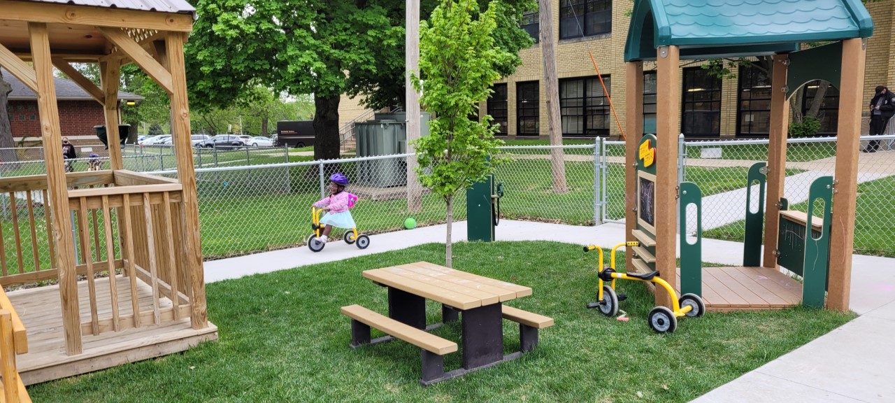 playground at Head Start with a child riding a tricycle