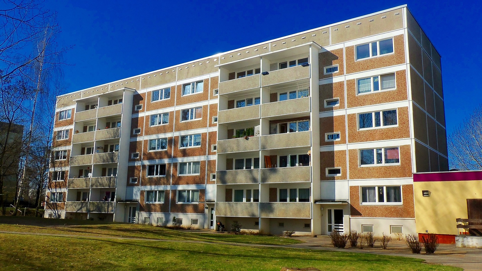 apartment building in an image with a blue sky