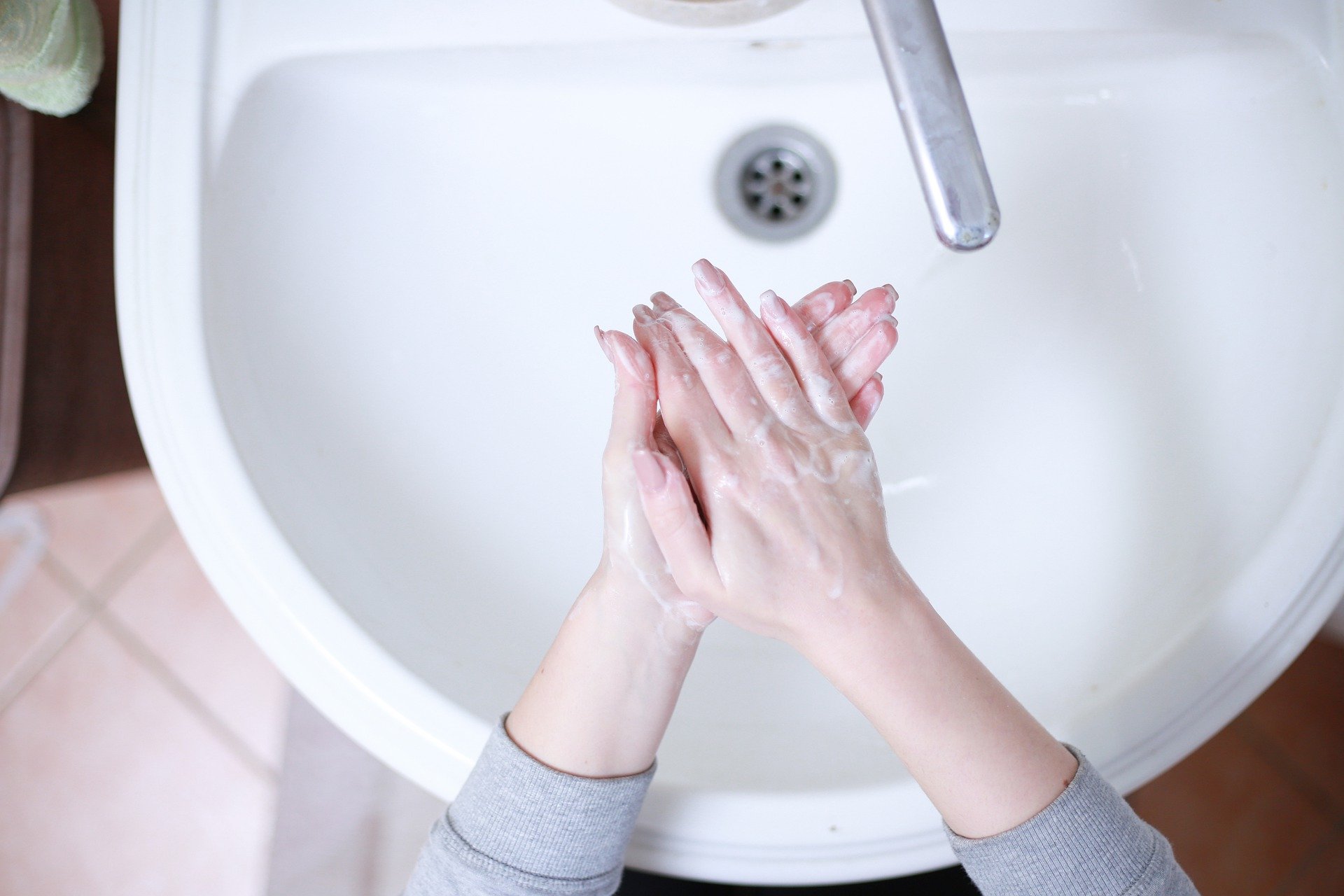 Woman washing her hands at a sink